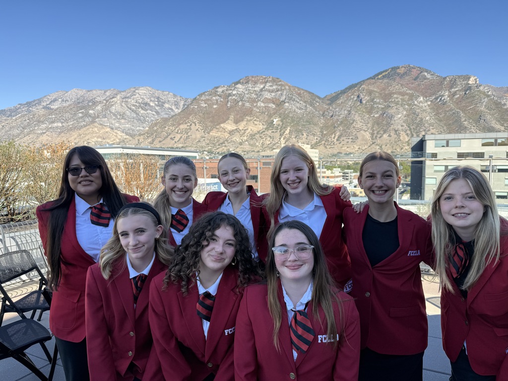 students wearing red jackets posing for a picture