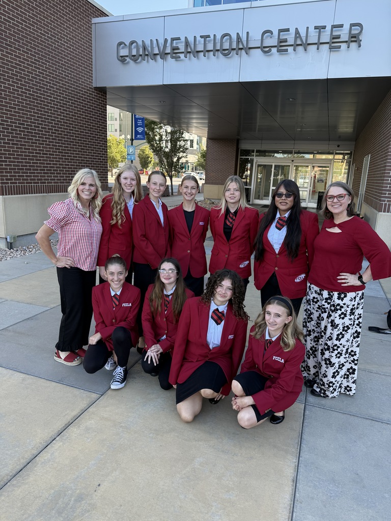 students wearing red suit jackets and ties