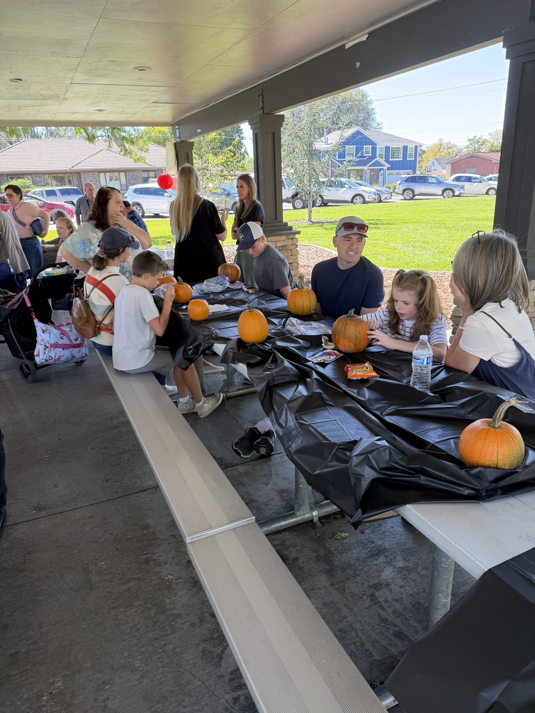 families painting pumpkins
