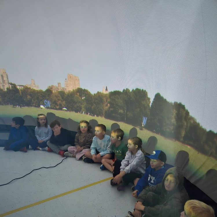 students learning in the star dome