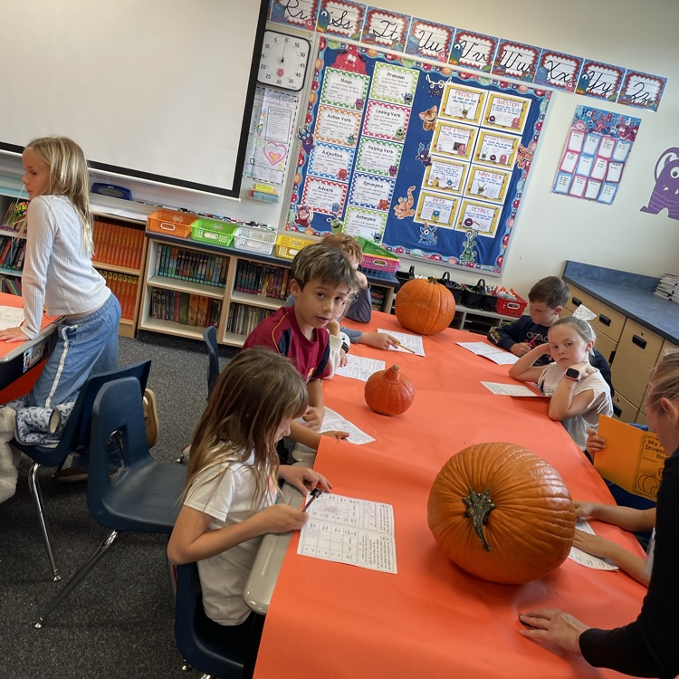 kids carving pumpkins and counting seeds 