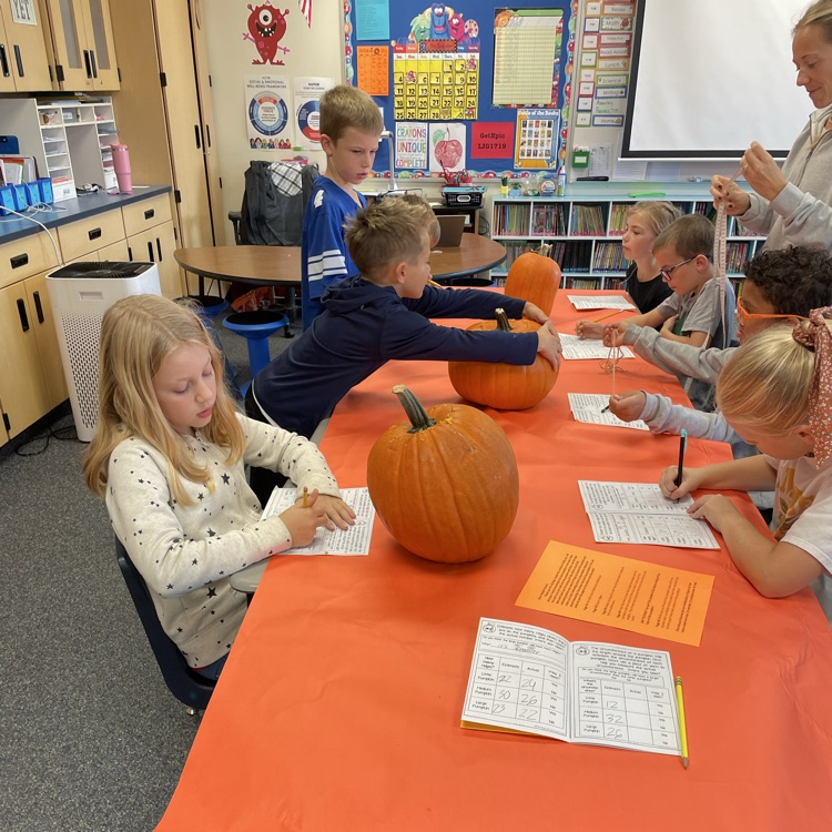kids carving pumpkins and counting seeds 