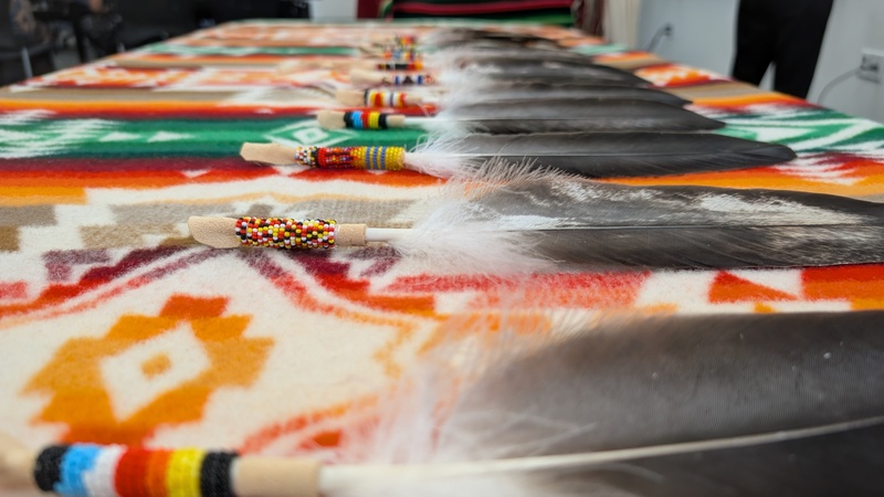 beaded feather laid out on a table
