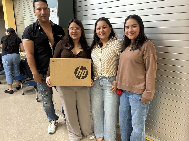 Family posing with their new computer.