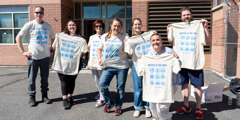 Volunteers posing with their shirts from the United Way Day of Caring