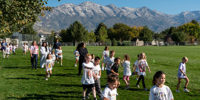 Students and community members participate in the Hawk Walk at Highland Elementary