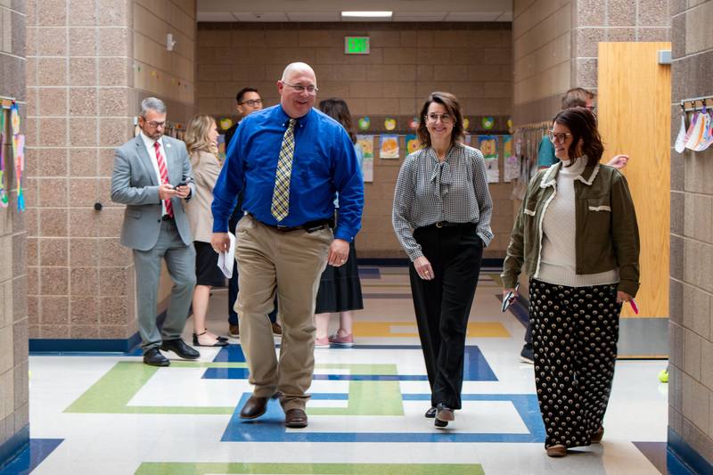 Henderson walks down the school hall with Springside administrators