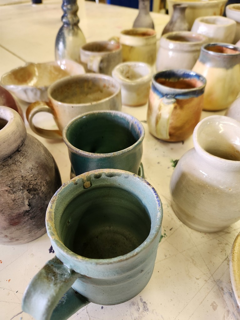 assorted pottery mugs