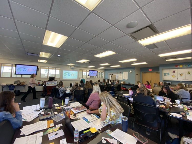 Teachers listening to math publishers presenting 