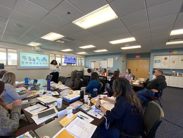 Teachers listening to math publishers presenting 