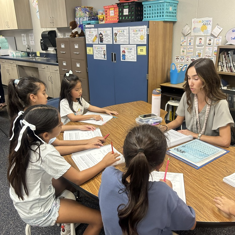 another teacher working with students and small group