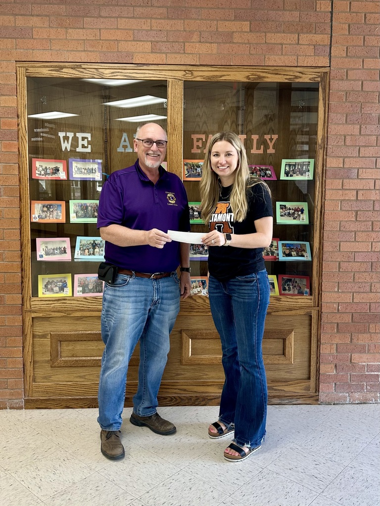Lion Kenny Shumaker presenting check to Mentoring Program Supervisor, Jenna Murray