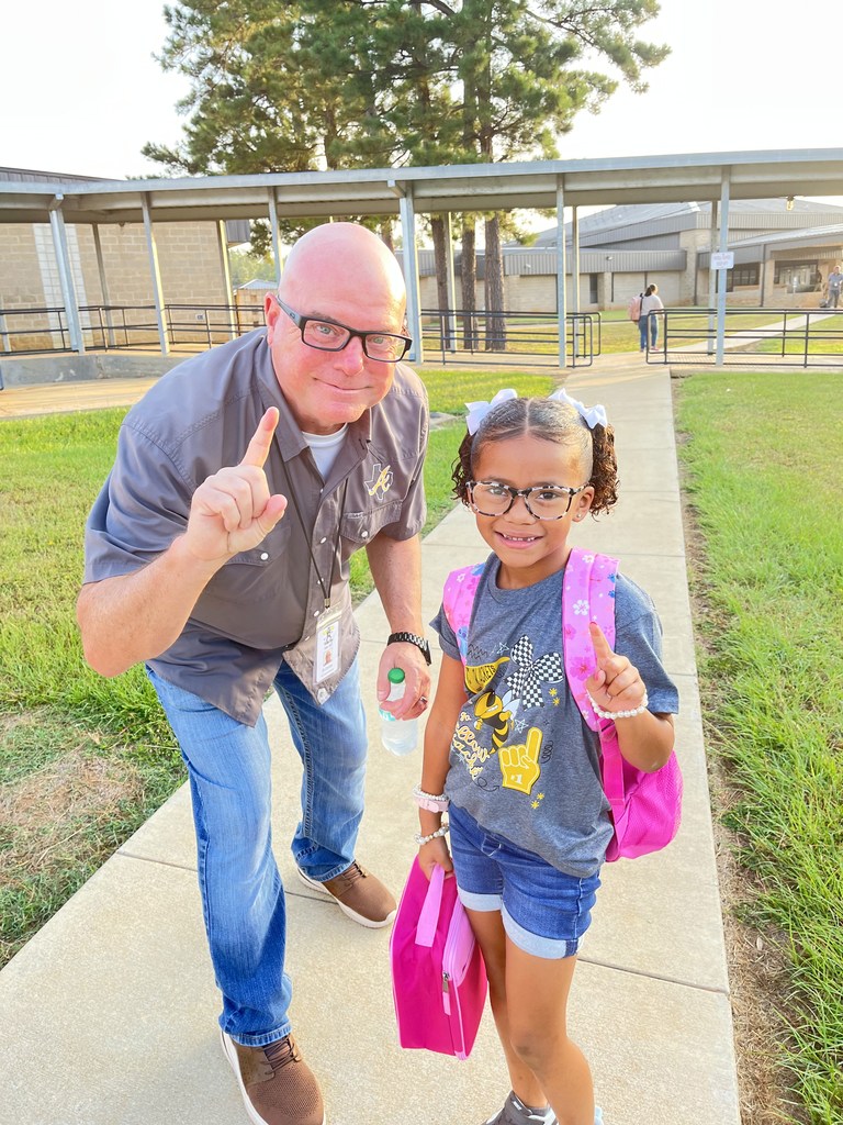 Mr. Conley and Jayleigh smiling with the number one