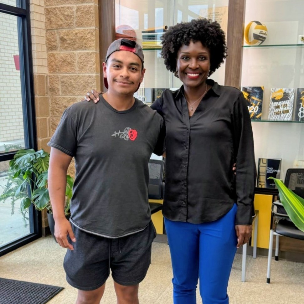 former student with his arm around Mrs Dorsey