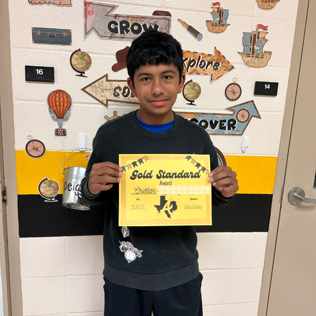 Male student holding Gold Standard Award certificate