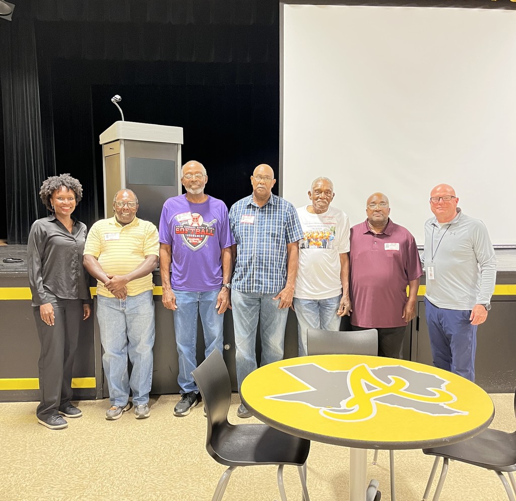 one woman and six men standing next to each other