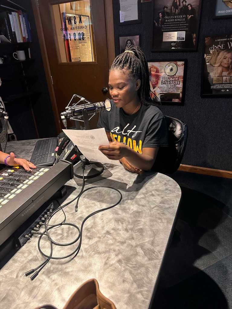 Student reading PSA into a microphone