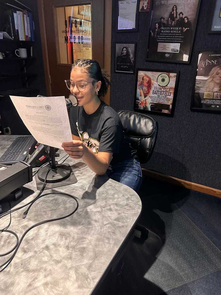 Student reading PSA into a microphone