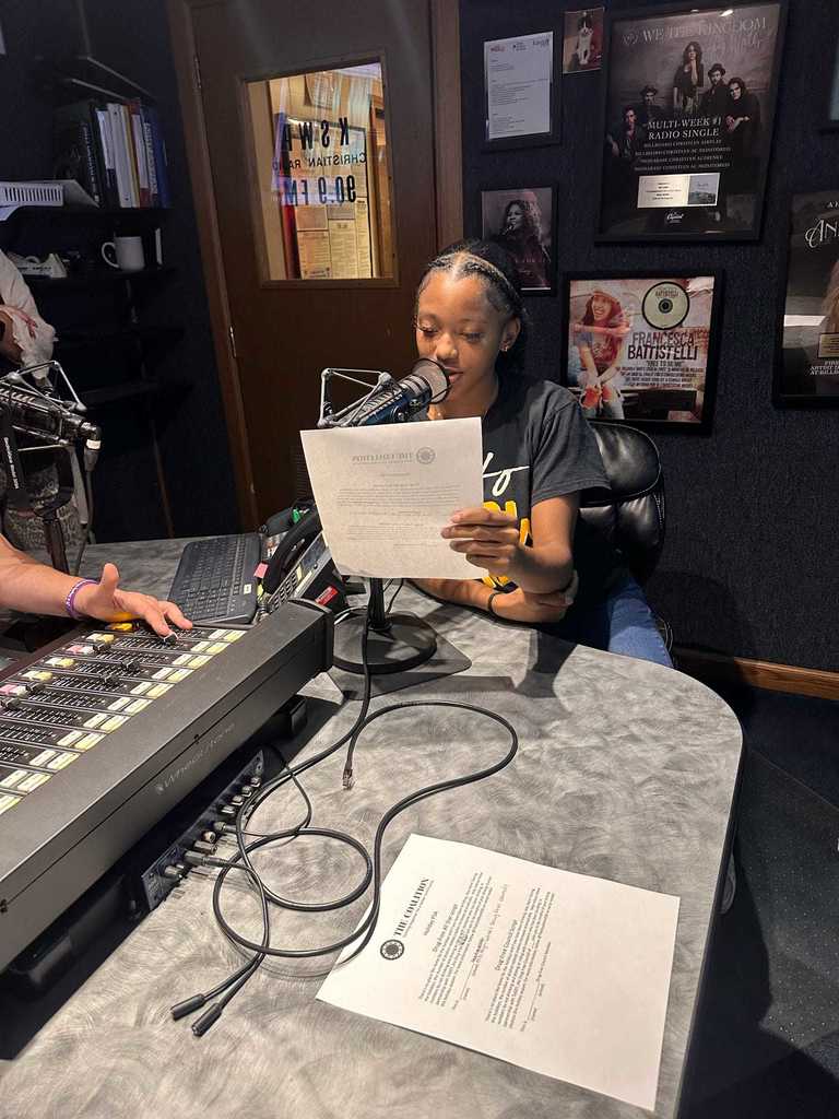 Student reading PSA into a microphone