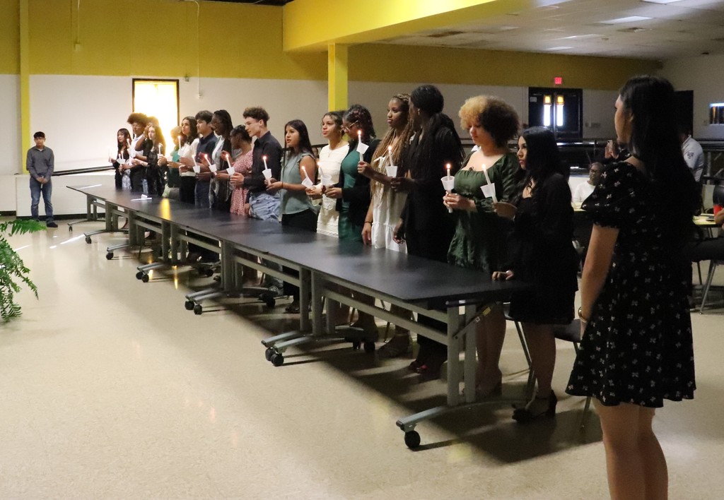 Inductees holding candles