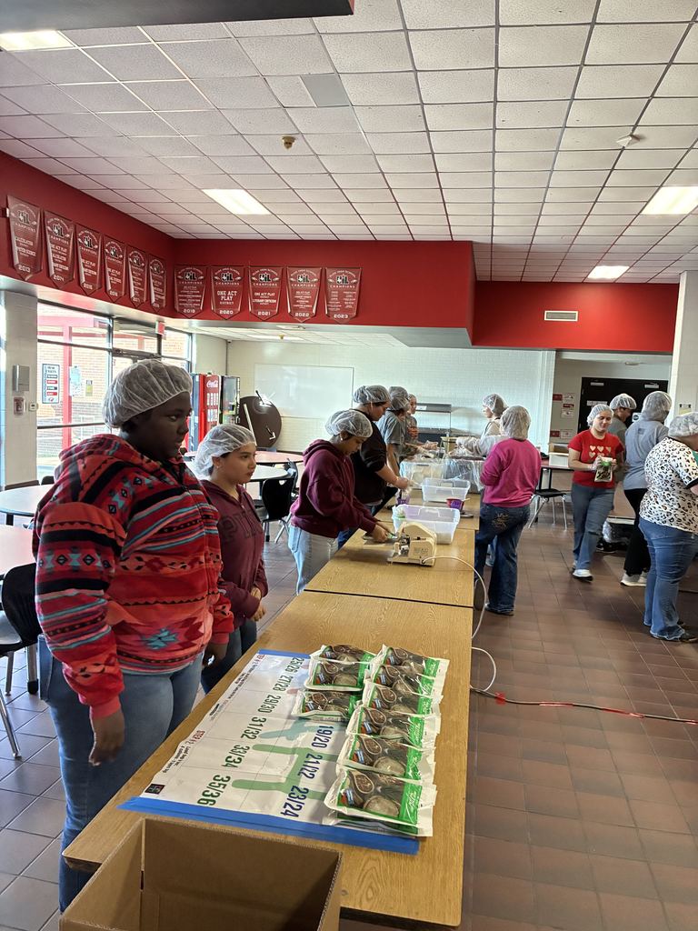 students wearing hairnets packaging meals