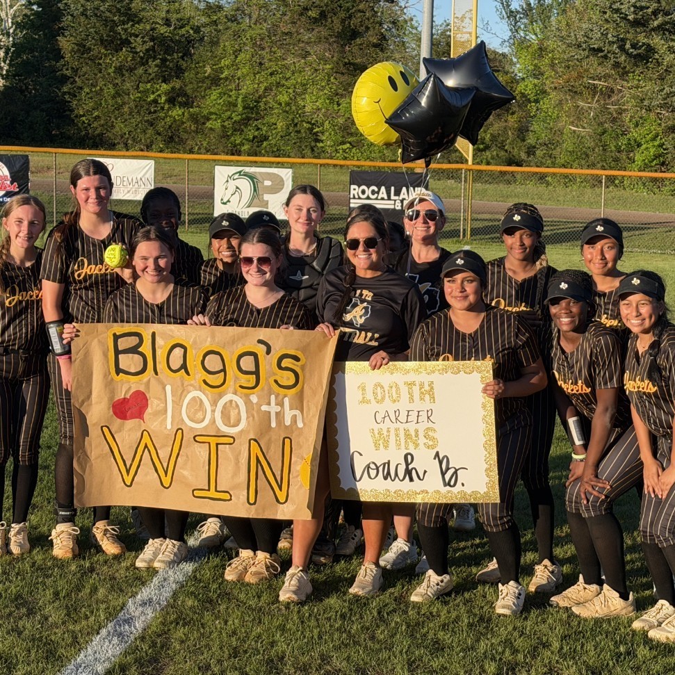 softball team posing with banner