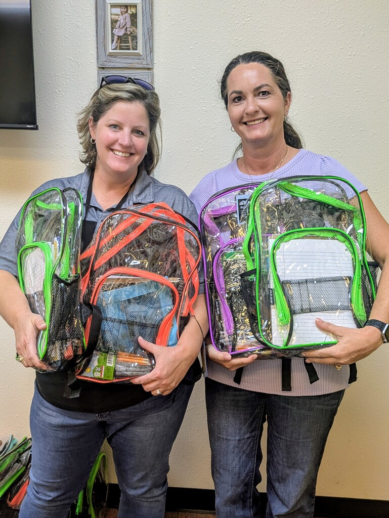 Administrators holding backpacks