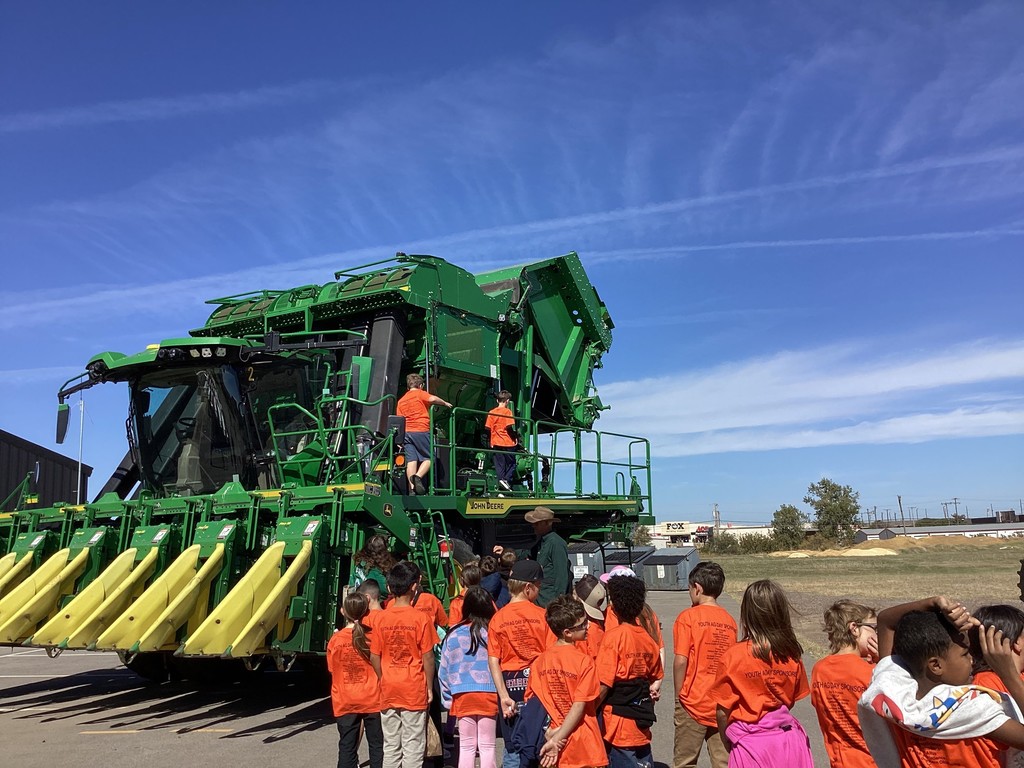 students looking at a tractor