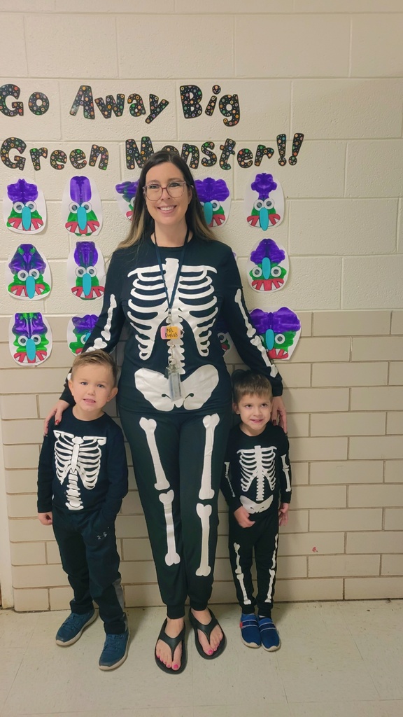 teacher and students dressed as skelltons