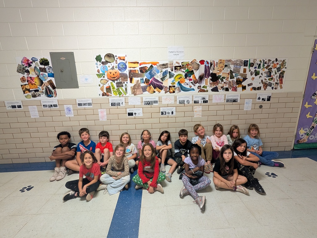 student posing with their work