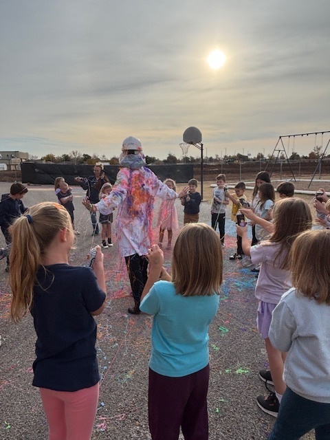 principal being sprayed with silly string.