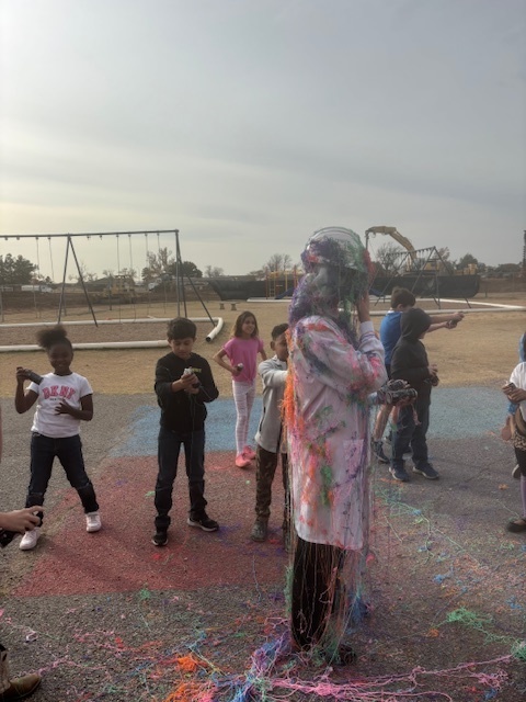 principal being sprayed with silly string.