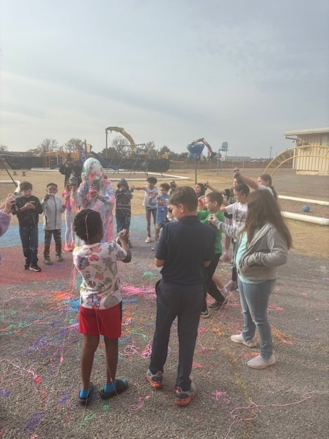principal being sprayed with silly string.