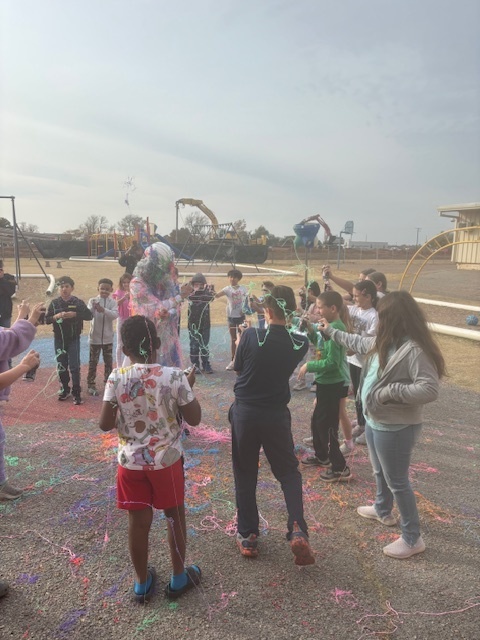 principal being sprayed with silly string.
