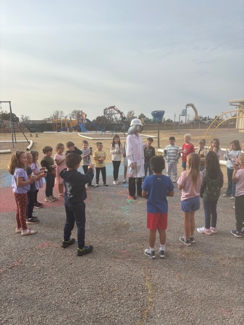 principal being sprayed with silly string.