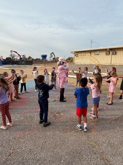 principal being sprayed with silly string.