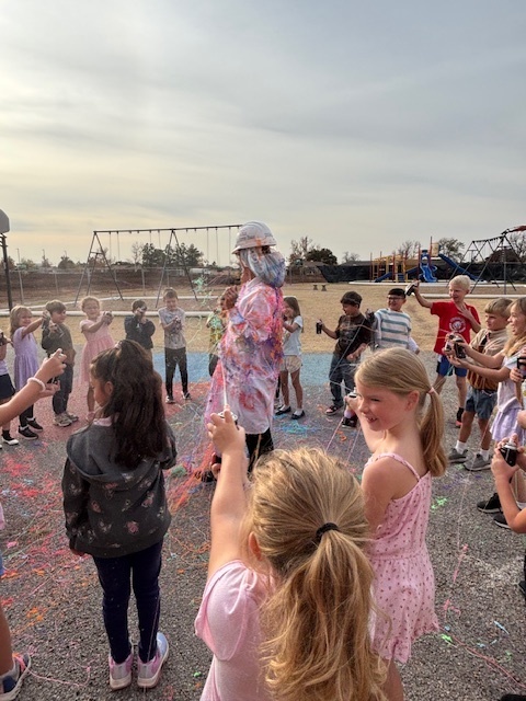 principal being sprayed with silly string.