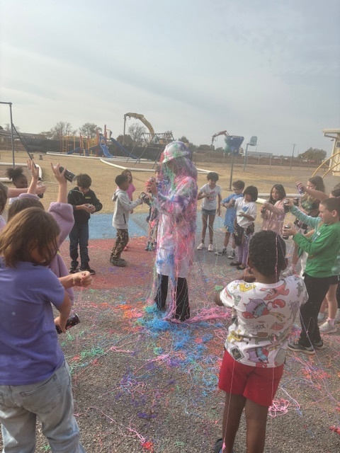 principal being sprayed with silly string.
