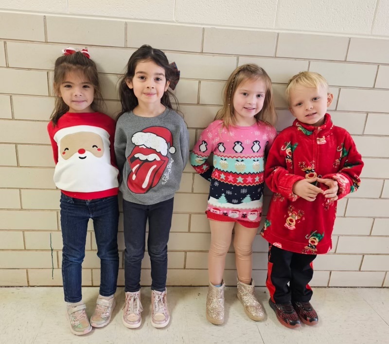 Students wearing Christmas sweaters.