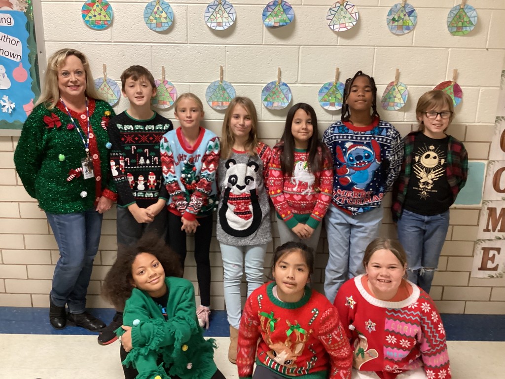 Students wearing Christmas sweaters.
