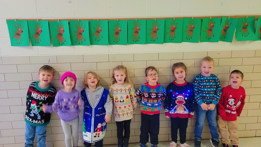 Students wearing Christmas sweaters.