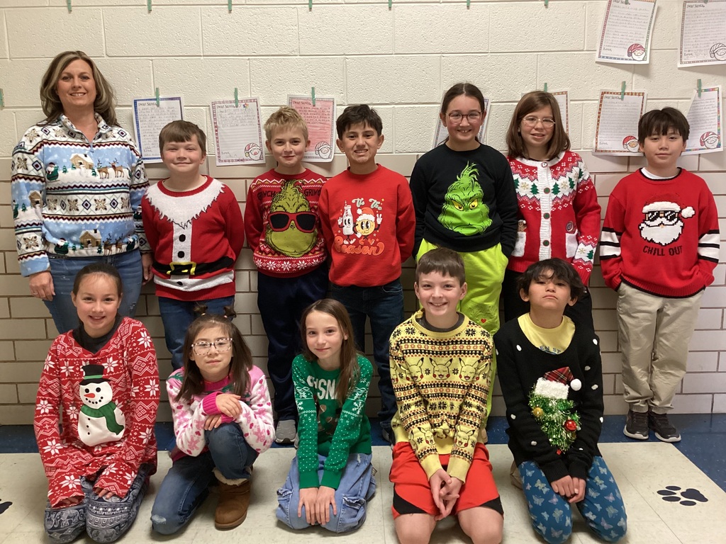 Students wearing Christmas sweaters.