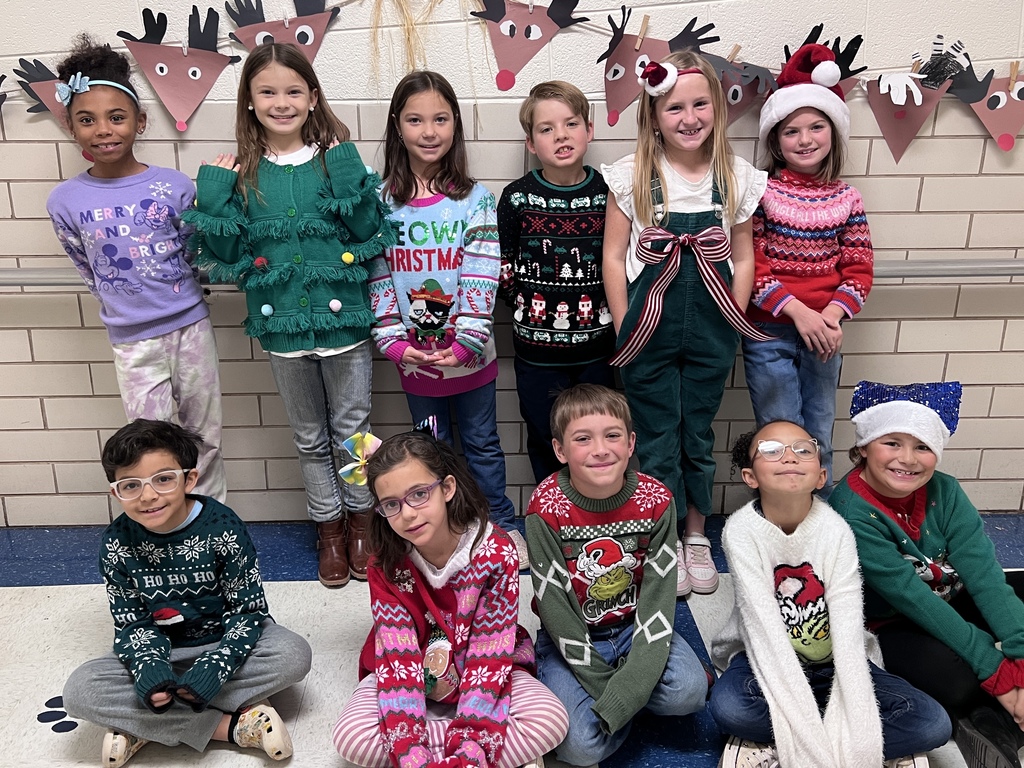 Students wearing Christmas sweaters.