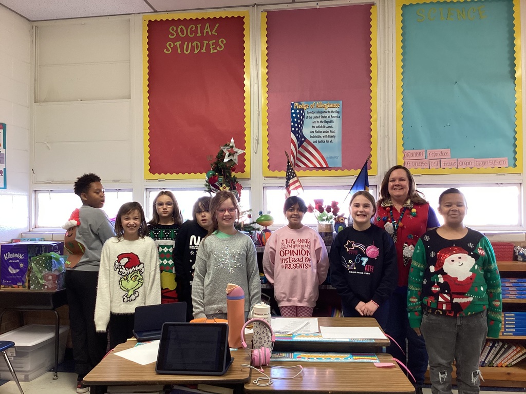 Students wearing Christmas sweaters.