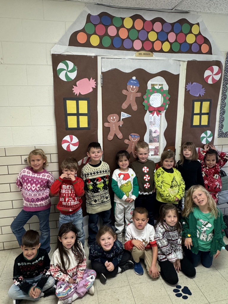 Students wearing Christmas sweaters.