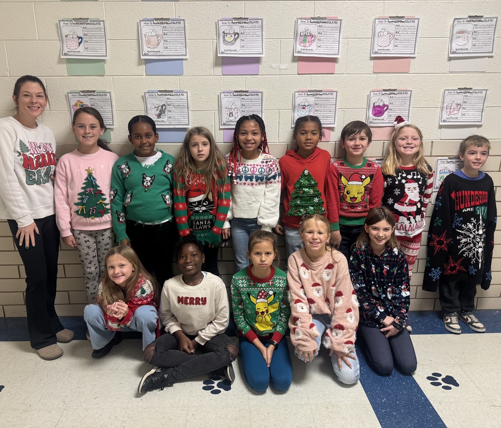 Students wearing Christmas sweaters.
