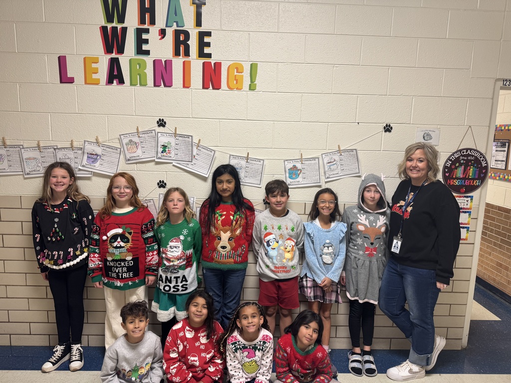 Students wearing Christmas sweaters.