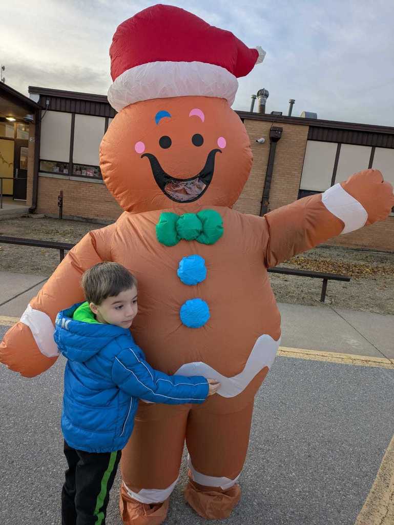 Gingerbread woman hugging a student. 