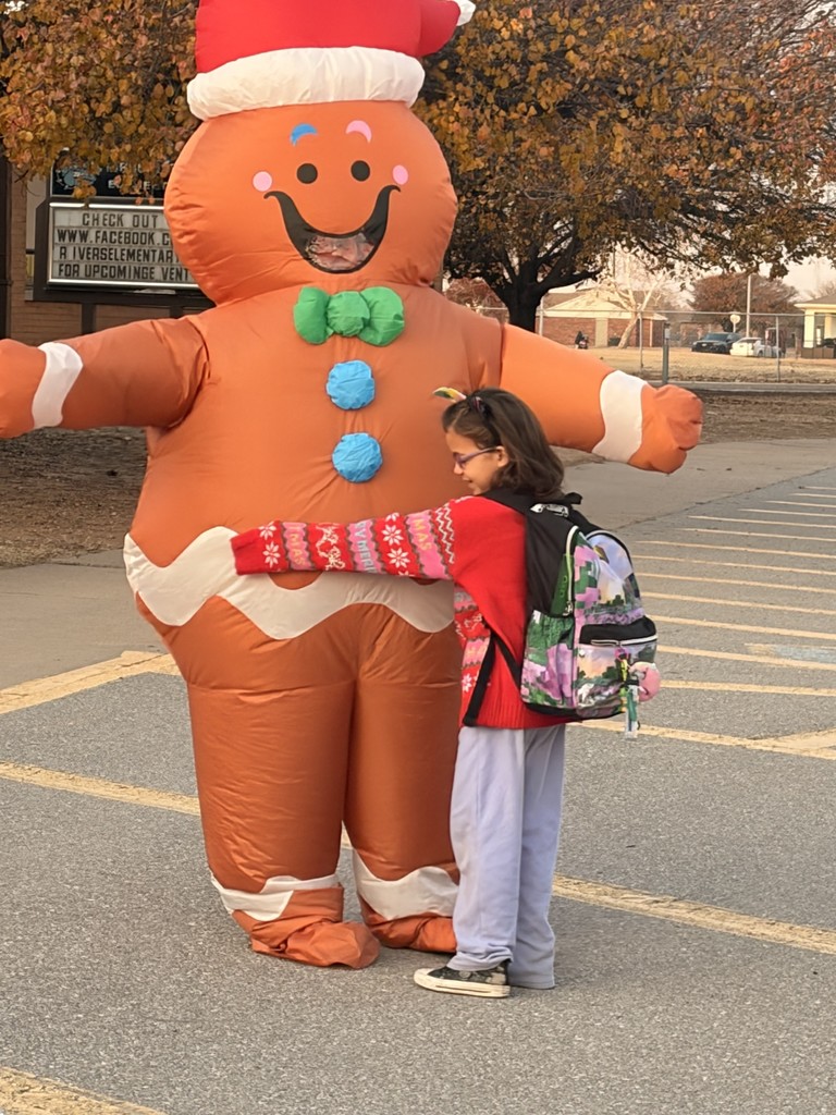 Gingerbread woman hugging a student. 