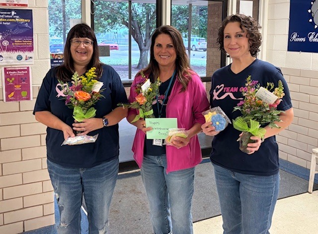 Administrative Assistants with flowers and gifts.